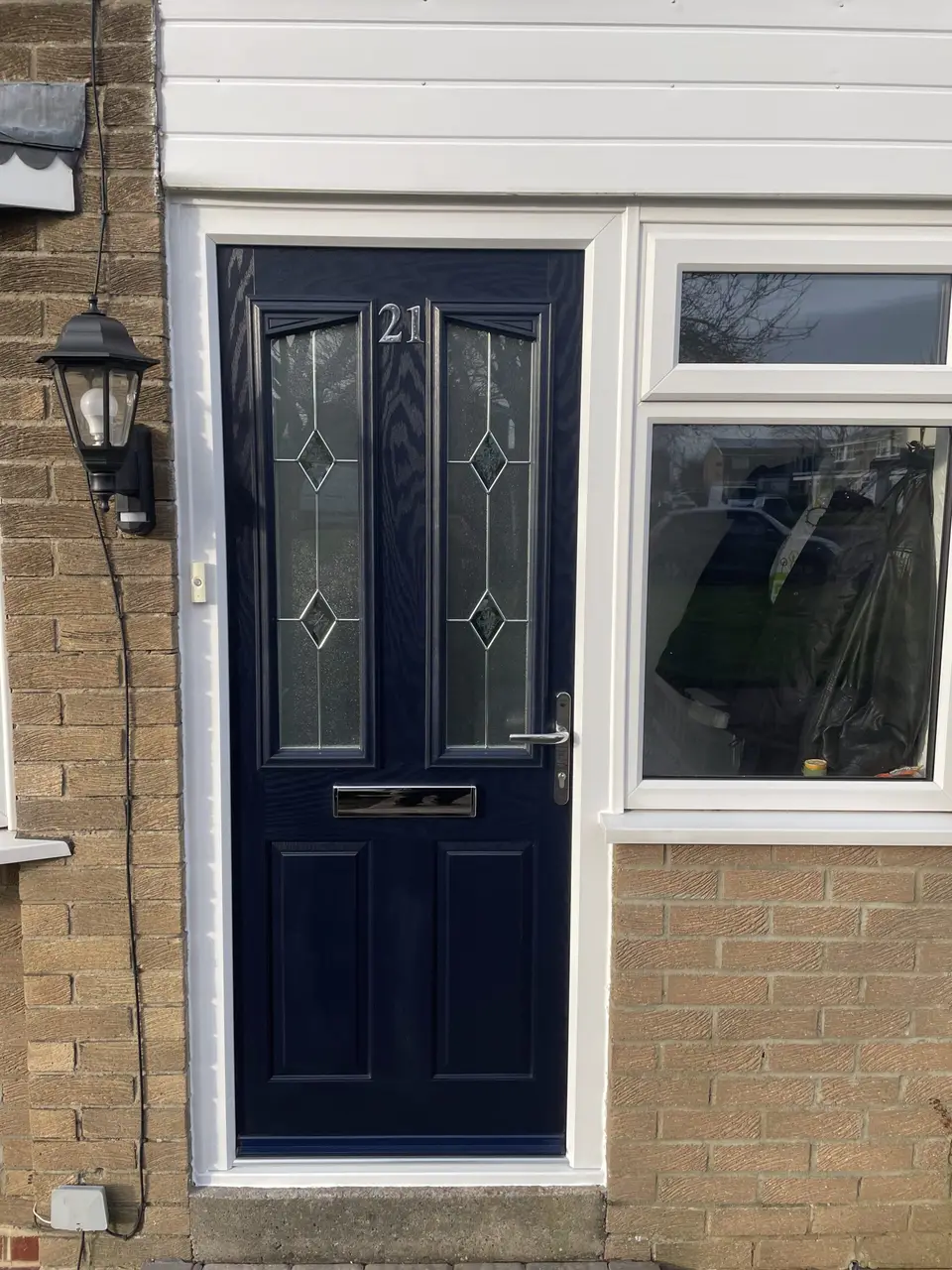 Navy composite door and uPVC window, Newcastle Navy composite front door with leaded glass next to a white uPVC window on a Newcastle house