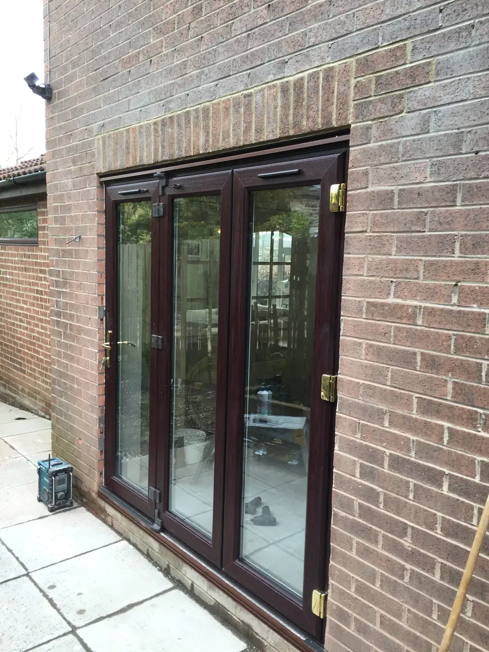uPVC bi-fold doors in Newcastle Rosewood-finish uPVC bi-fold doors fitted in a brick extension in Newcastle upon Tyne